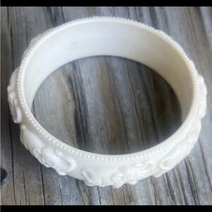 Faux ivory bracelet with raised elephants